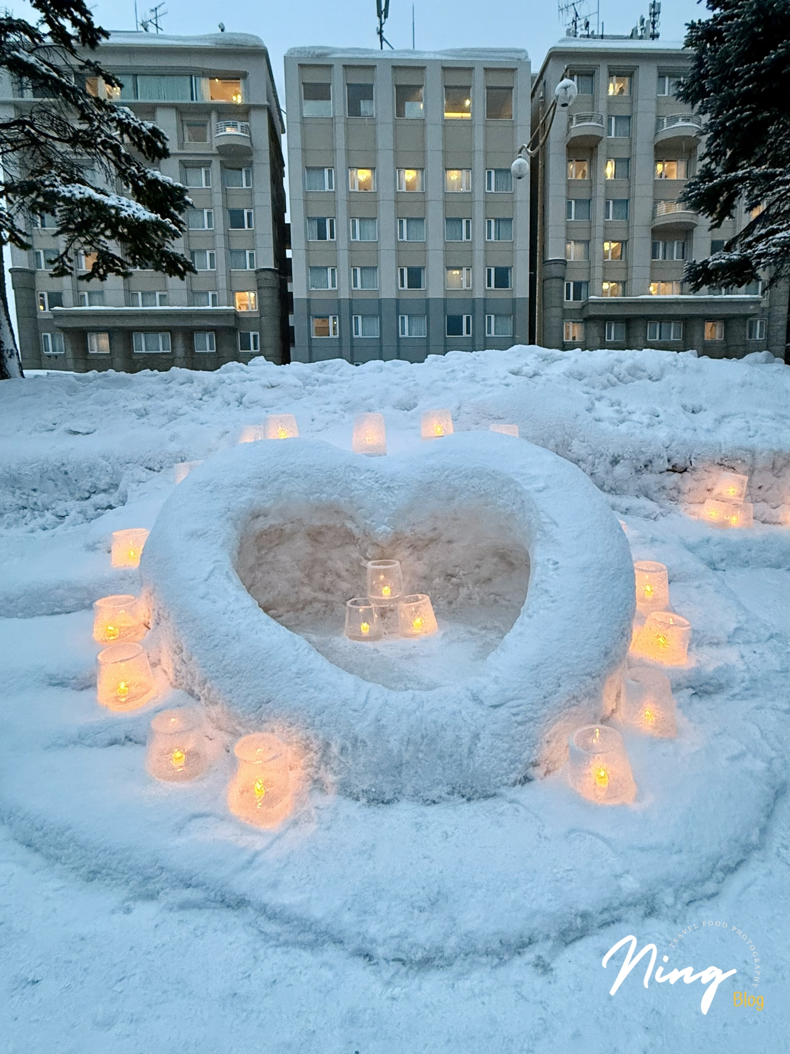 Heart-shaped snow sculpture with candle lights at Otaru Snow Light Path.